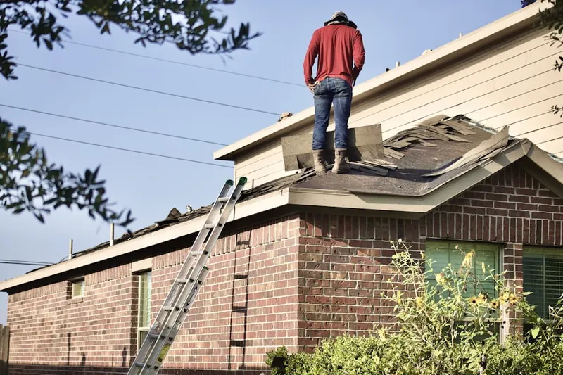 Professional roofer working on a residential roof in North Dennis